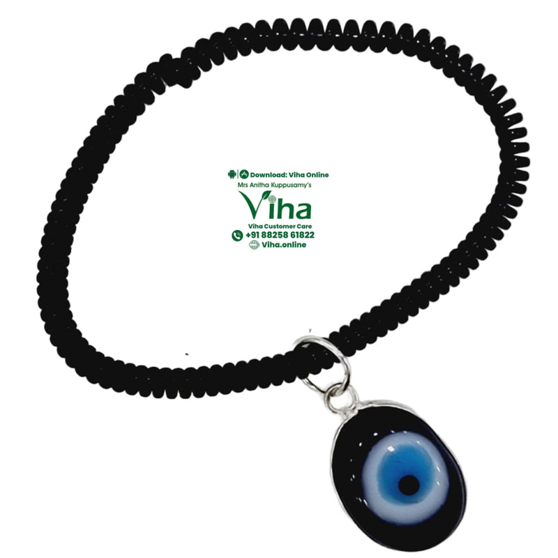 Evil Eye Anklet, a spiral band with a blue, white and black glass eye pendant