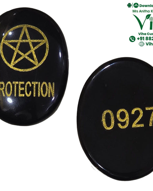 Protection Zibu Coin - Black Agate, a glossy oval stone engraved with a symbol