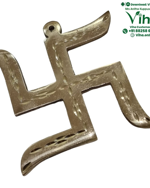 Swastik Yantra, a gold-toned metallic swastika charm featuring etched patterns and a top loop