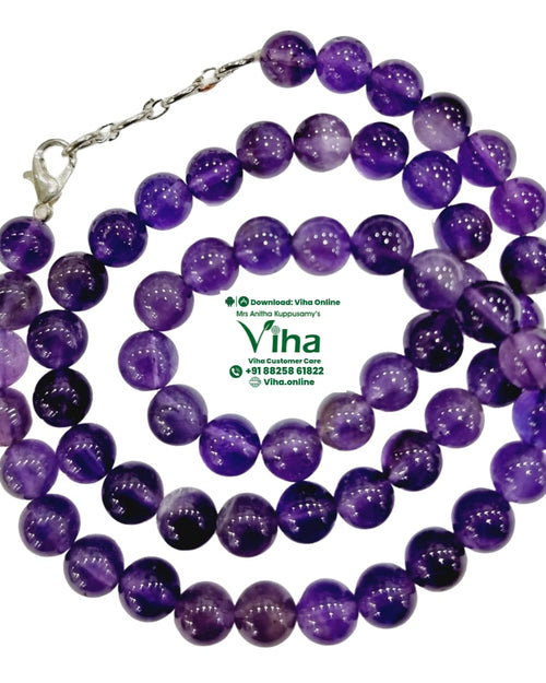 Amethyst Mala, a coiled strand of purple round beads with a silver-toned clasp