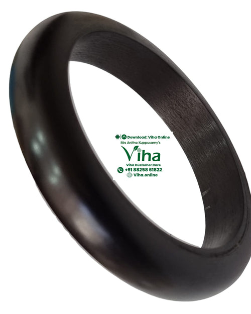 Karungali Wood Bangle, a dark brown, thick, smooth-surfaced ring with a curved outer contour and a flat-textured inner side