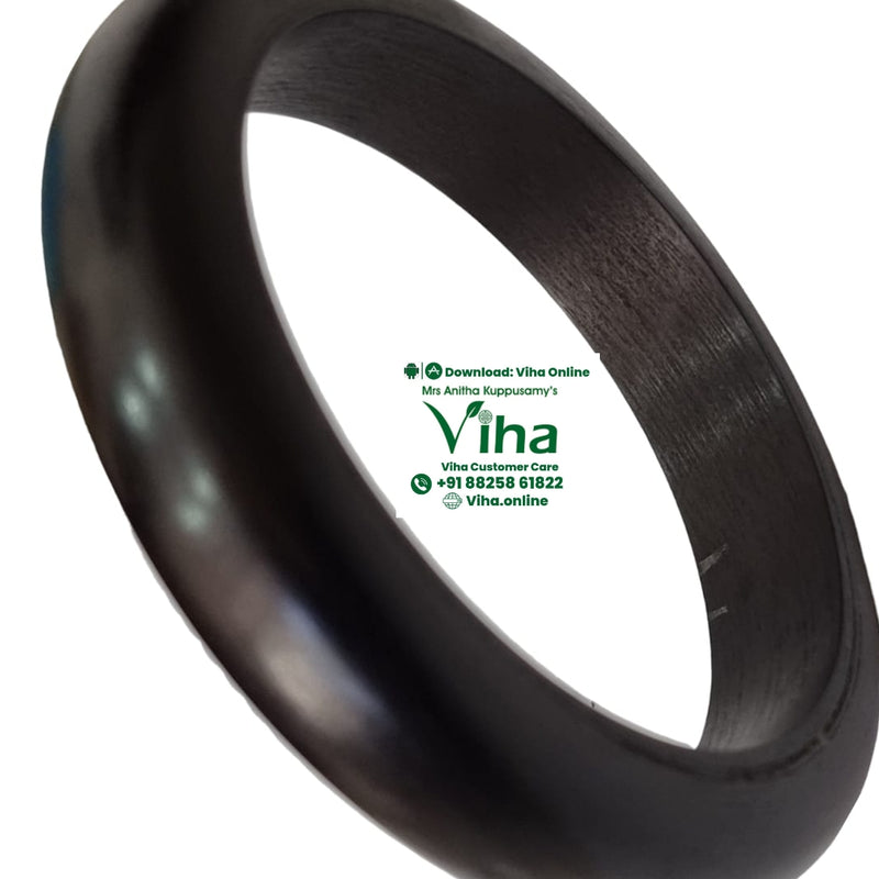 Karungali Wood Bangle, a thick, dark brown, rounded ring with a smooth finish and a slightly angled interior surface