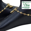 Impon Anklets, two gold-toned anklets with linked heart shapes and hanging bell charms are displayed on two dark mannequin feet