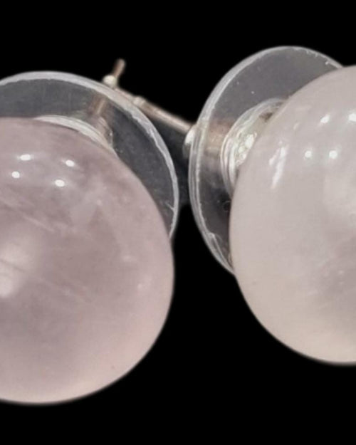 Rose Quartz Studs, a pair of round pale pink gemstone earrings on a black background