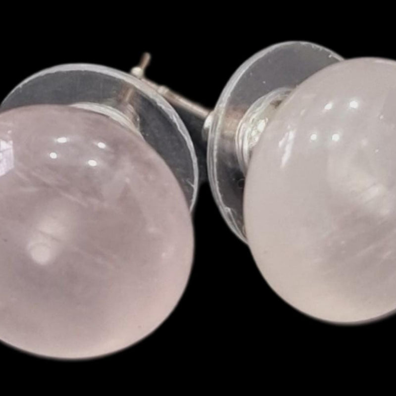 Rose Quartz Studs, a pair of round pale pink gemstone earrings on a black background