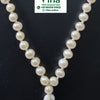 Pearl Round Beads Mala 108+1, a close-up of a glossy white beaded necklace with a white and purple thread tassel at the bottom