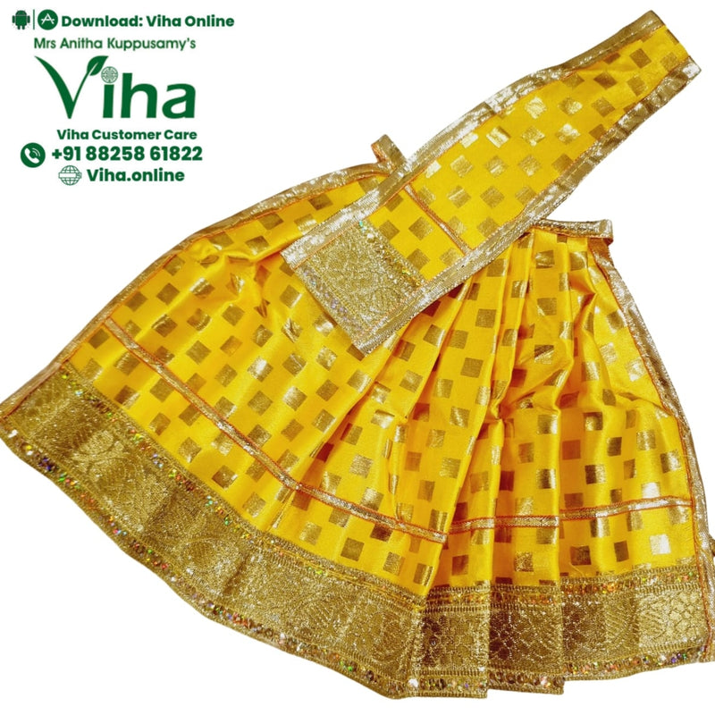 Amman Pavadai Set, a yellow garment patterned with shiny gold-toned squares, featuring wide metallic gold-toned borders and a pleated skirt construction