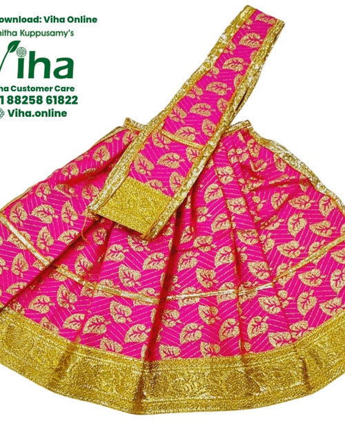 Amman Pavadai Set, a flared pink garment with shiny gold-toned leaf patterns and a glossy, textured border includes one long diagonally placed matching sash