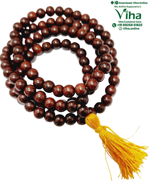 Sengali Mala, a coiled strand of dark reddish-brown wood beads with a yellow tassel