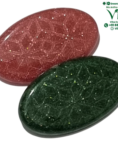 Pair of oval glittered saree pins in red and green