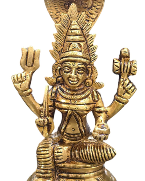 Karumariyamman in brass, four-armed figure seated under a multi-hooded serpent canopy on a round lotus base