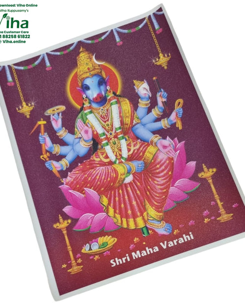 Varahi Amman Photo - Big, a sparkly rectangular print features a blue-skinned multi-armed figure seated on a pink lotus amid lamps and garlands
