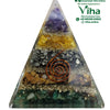 Nubian Prosperity Pyramid, a pyramid containing layered purple, yellow, grey, brown, and green stones with metallic flakes and a copper-toned spiral