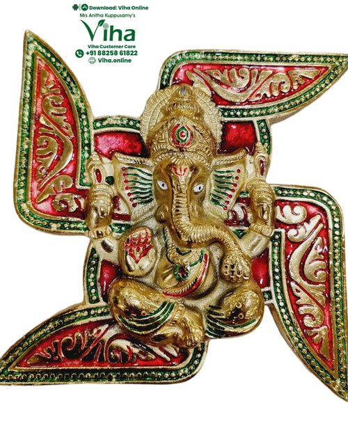 Swastik Ganesha Wall Hanging, a gold-toned, red, and green swastika plaque centered with a gold-toned elephant-headed figure