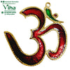 Om Wall Hanging, a gold-toned metallic Om symbol featuring glossy red enamel fills, one green area, and a red stone detail with a loop at the top
