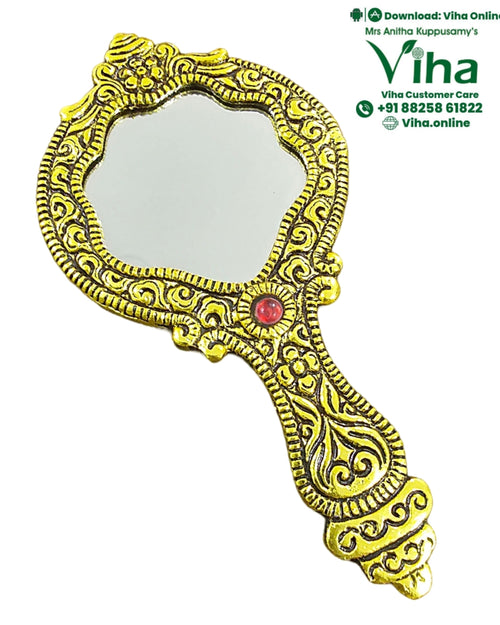 Hand Mirror, a gold-toned hand mirror features intricate embossed patterns, a central red stone, and an asymmetrical scalloped frame with a patterned handle