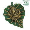 Green Leaf Ganesha Wall Hanger, a green-textured leaf sculpture featuring an elephant-headed figure in gold-toned finish with multiple radiating stems