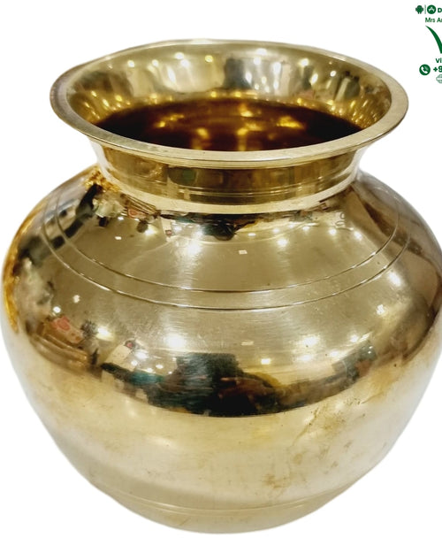 Heavy Lotta, squat brass vessel with horizontal ridge bands around the body, wide flared rim and short narrow neck
