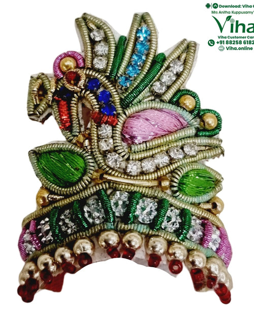 Idol Mukut, an ornate embroidered patch with gold-toned wires, clear stones, green leaves, pink fabric, and dangling beads