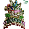Idol Mukut, an ornate embroidered patch with gold-toned wires, clear stones, green leaves, pink fabric, and dangling beads
