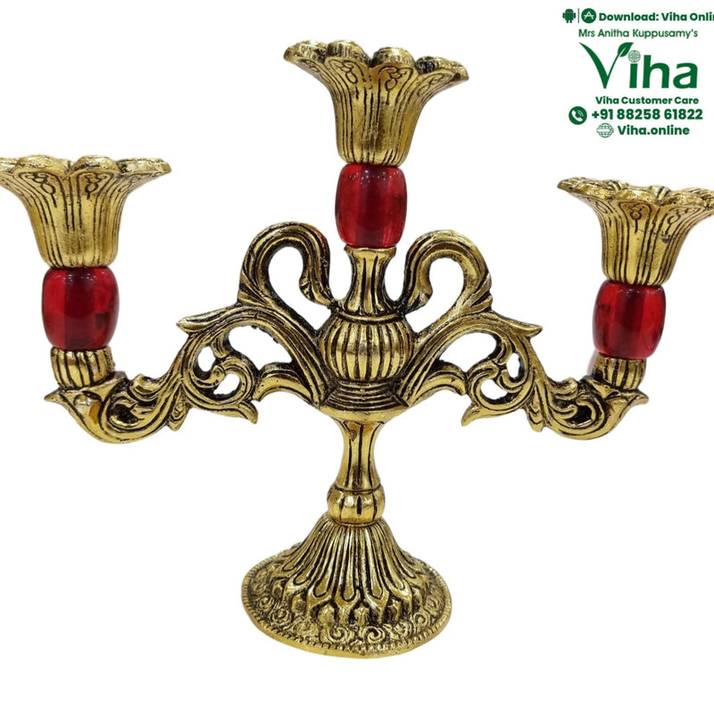 Antique brass candle stand, three fluted candle cups on scrolled arms with red stone accents