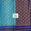 Soft Silk Saree with Blouse & with Grand Pallu, a folded textile with light blue and dark blue sections, featuring gold-toned woven repeating patterns