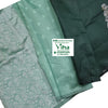 Cotton Silk Saree with Blouse, folded teal fabric features silver-toned woven floral patterns, a smaller peacock motif, and scattered small motifs