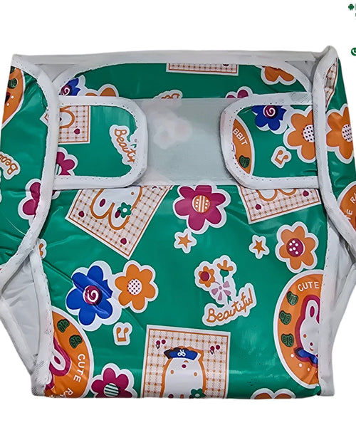 Water Proof Velcro Diaper, a green glossy fabric garment with white trim, decorated with colorful floral prints, orange patterns, and text motifs