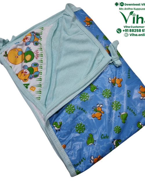 Baby Sheet With Towel - Water Proof, folded light blue towel with patterned blue section and cartoon bird print corner