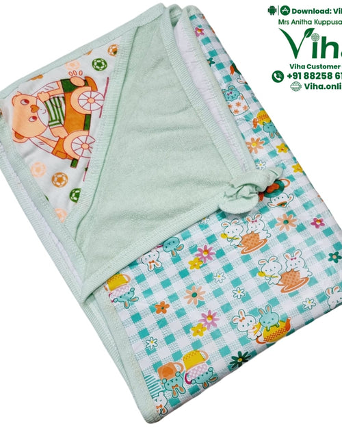 Baby Sheet With Towel - Water Proof, a folded light-green and white textile piece featuring cartoon rabbit and bear patterns with small floral and ball details