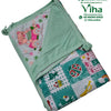 Baby Sheet With Towel - Water Proof, folded green and white textile featuring patterned cartoon prints, sewn hems, and tied corners