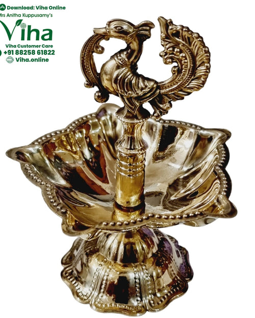 Brass annapakshi lamp, twin swan finial over a deeply fluted scalloped oil dish with beaded rim