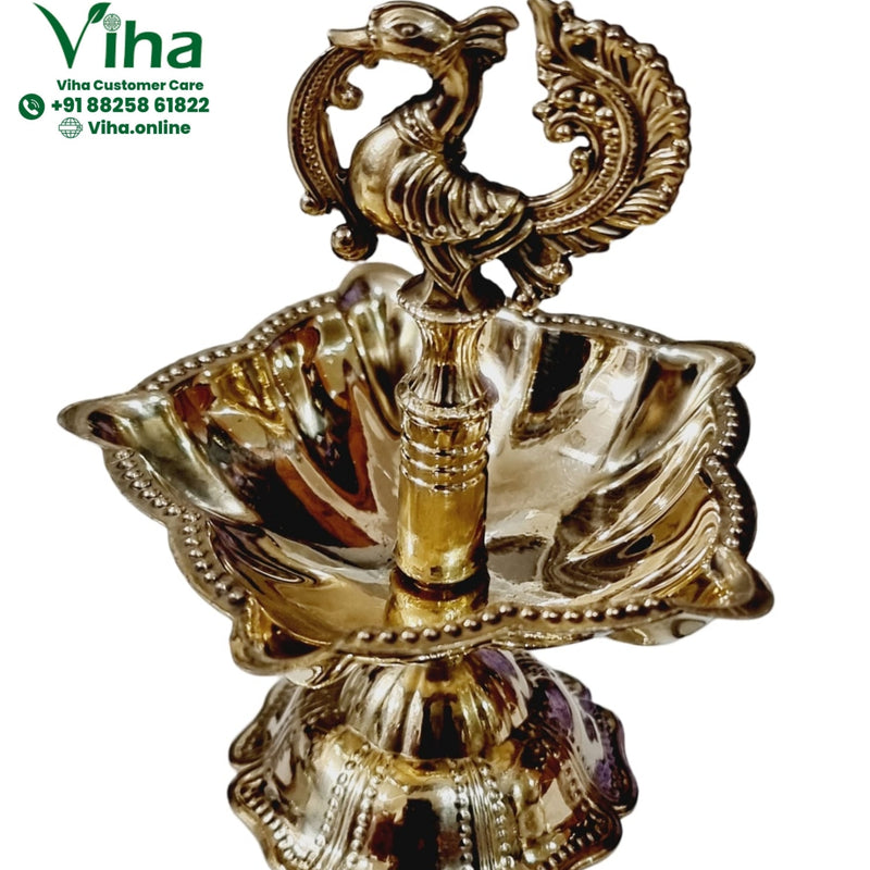 Brass annapakshi lamp, twin swan finial over a deeply fluted scalloped oil dish with beaded rim