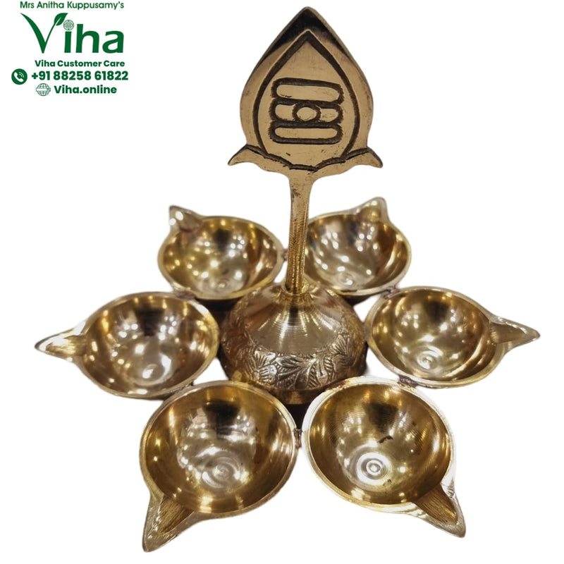 Arumuga six-face vel lamp in brass, six leaf-shaped oil cups ringing a central vel finial