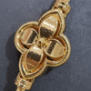 Impon Mugappu Chain, a gold-toned chain with a four-petalled flower-shaped central pendant