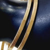 Impon Bangle, two gold-toned, faceted square-profile bangles with ribbed texturing along sections of their surfaces