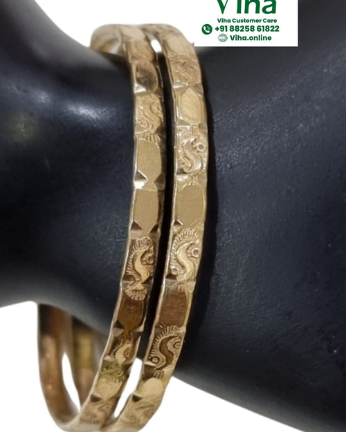 Impon Bangle, pair of gold-toned bangles with a faceted hammered texture, worn on a display wrist