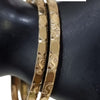 Impon Bangle, pair of gold-toned bangles with a faceted hammered texture, worn on a display wrist