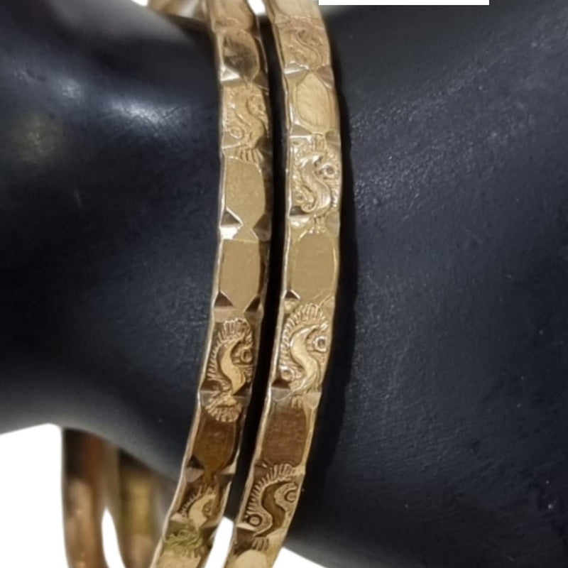 Impon Bangle, pair of gold-toned bangles with a faceted hammered texture, worn on a display wrist