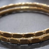 Impon Bangle, two gold-toned metallic bangles with a faceted block-patterned surface finish
