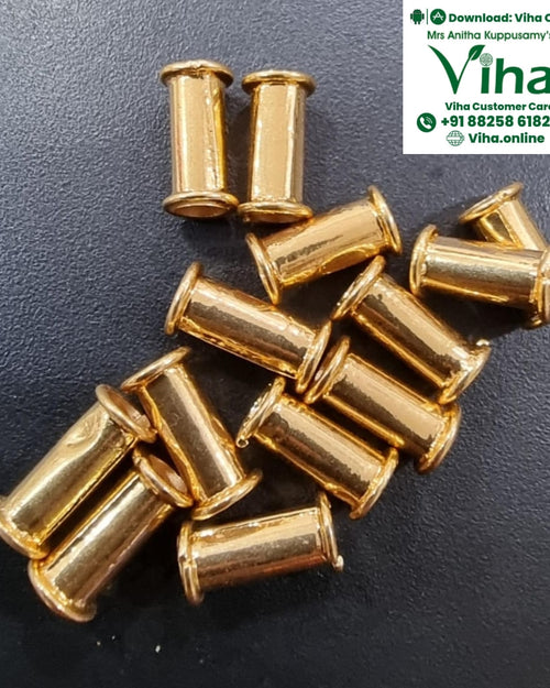 Impon Thali Nanal Kuzhai, loose gold-toned tube beads scattered on a dark surface