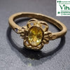 Impon Ring, band with a floral mounting and an oval yellow stone