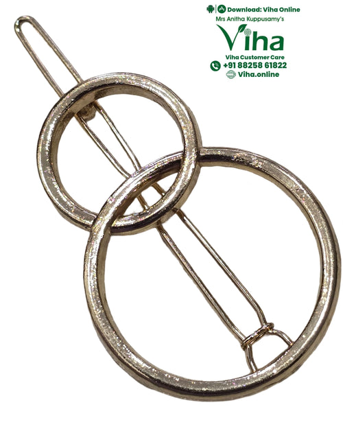 Hair Clip, a gold-toned metallic clip with two overlapping circular rings and a thin parallel pin passing through them