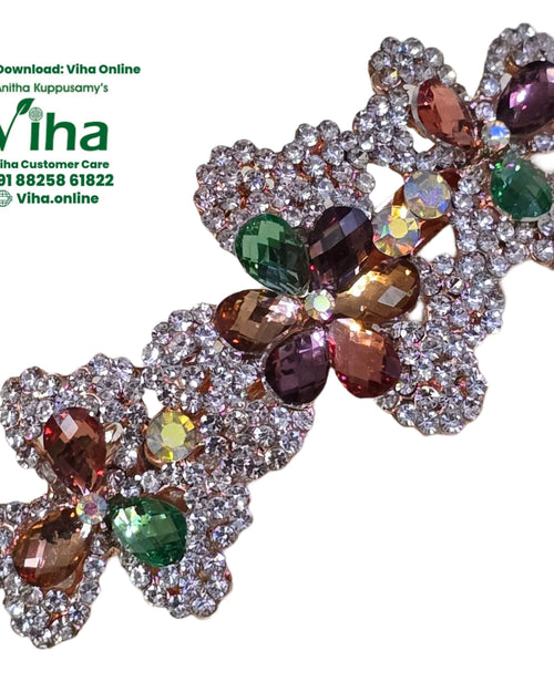 Hair Clip Studded with Stones in a floral design covered with clear, amber, and purple crystals