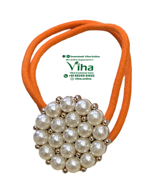 Hair Band with White Beads, an orange loop attached to a round, beaded ornament with nineteen white beads and sixteen metallic beads