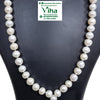 Natural Pearl Mala, a single strand of textured white oval beads draped over a black stand