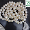 Natural Pearl Mala, a strand of glossy white round beads terminating in a white tassel