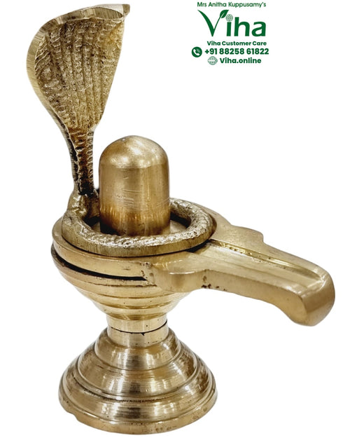 Naga Shivling - Brass, a gold-toned metallic sculpture with a fluted conical base, a central dome, a coiled snake, and an upright hooded snake behind it