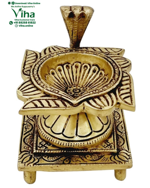 Naga swastik deepam in brass, cobra hood over a fan motif on a square swastik-engraved footed base