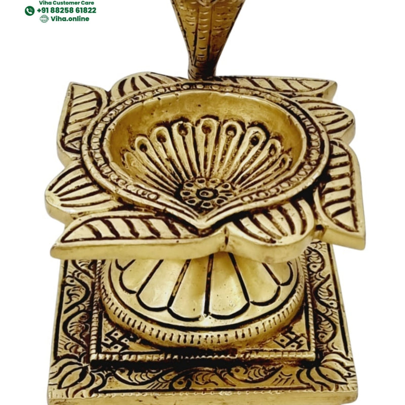 Naga swastik deepam in brass, cobra hood over a fan motif on a square swastik-engraved footed base